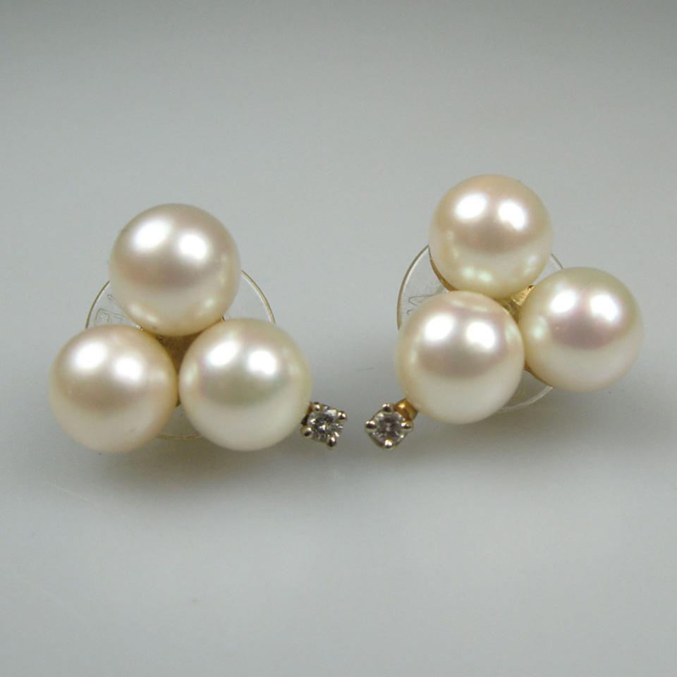 Pair Of 14k Yellow Gold Earrings each set with 3 cultured pearls and a small brilliant cut diamond
