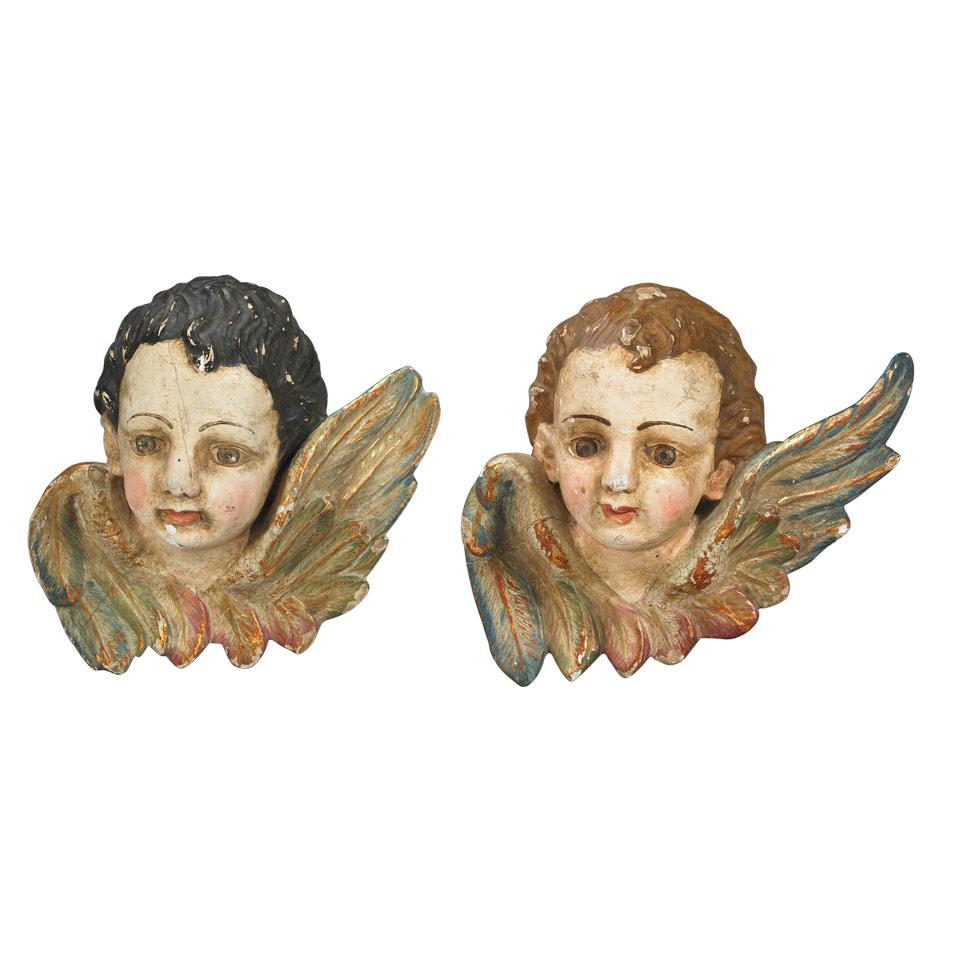 Two Italian Carved, Polychromed and  Parcel Gilt Cherubic Heads, early 20th century