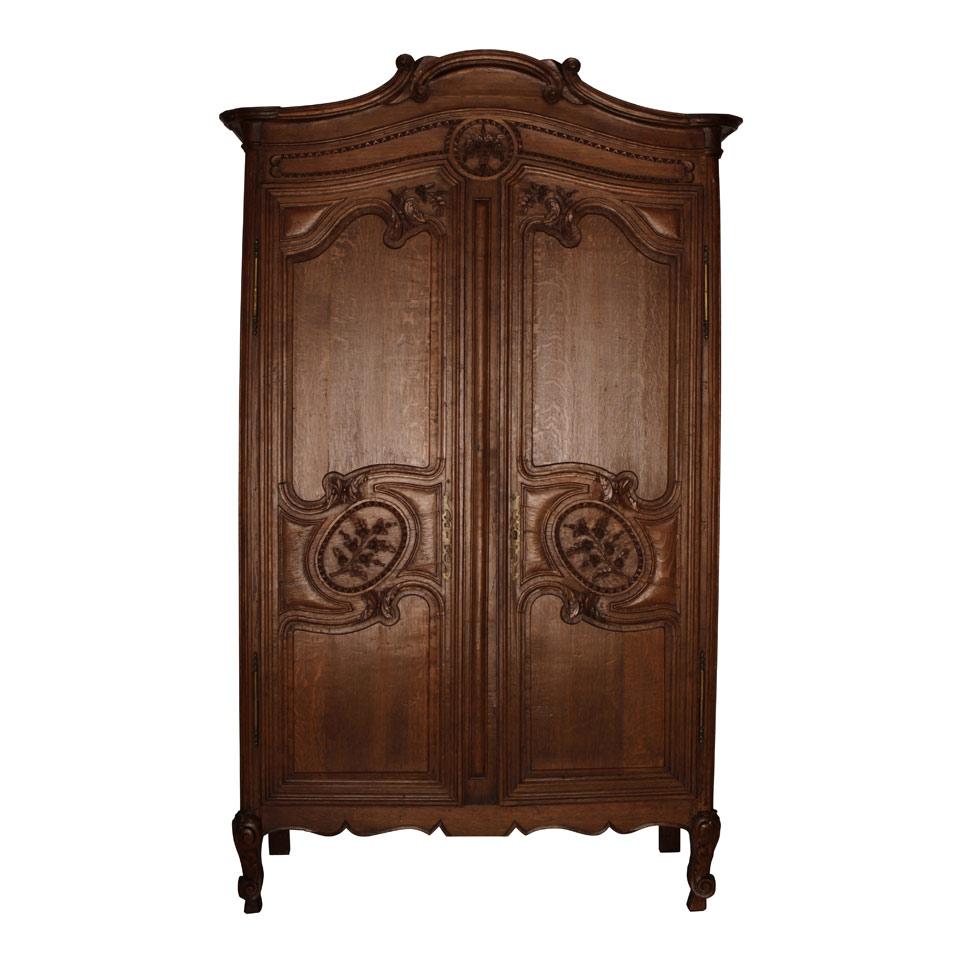 Late Nineteenth Century French Provincial Armoire with arched floral carved tri panelled doors 