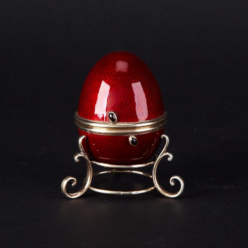 Russian Silver-Gilt and Engraved-Ground Translucent Red Enamel Egg on Stand