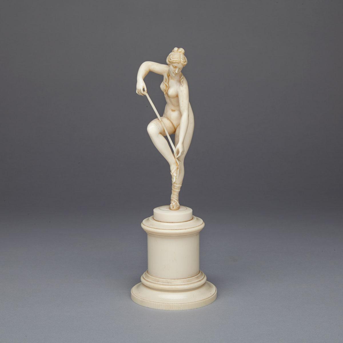 French Carved Ivory Figure of Aphrodite Lacing Sandal, 19th century