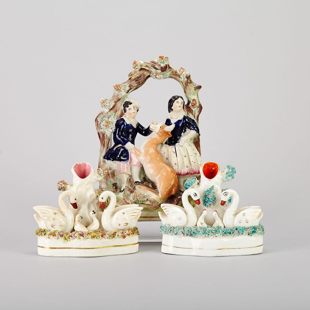 Two Staffordshire Swan Group Spill Vases and a Bower Group of Figures with a Deer, 19th century