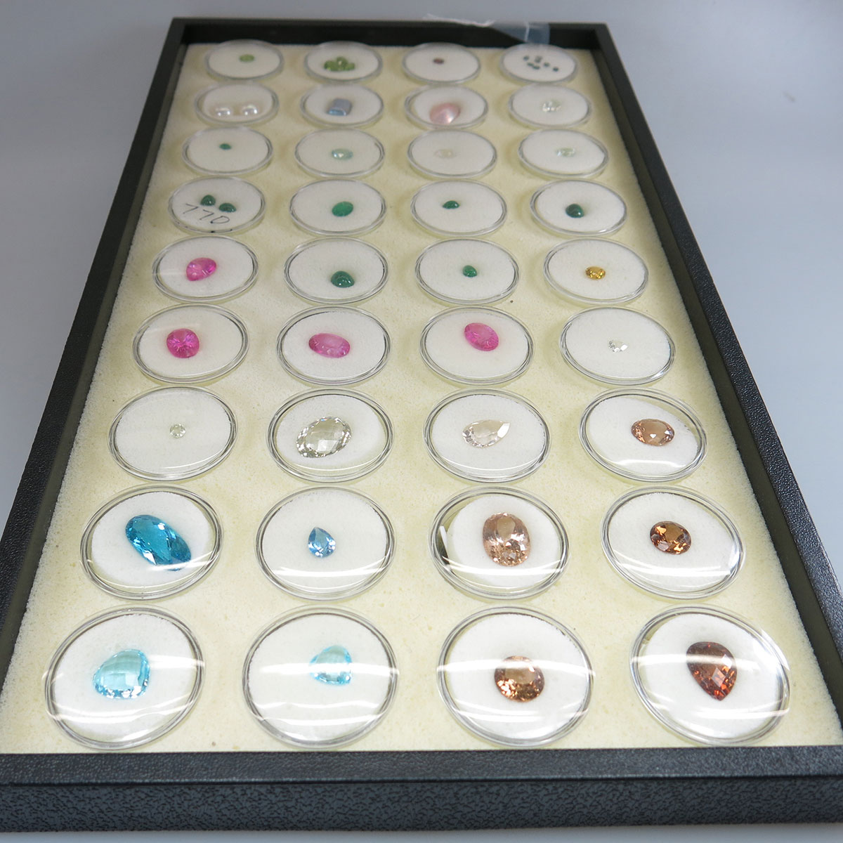43 Various Cut Unmounted Topaz, Peridots, Alexandrites, A Spinel, Emeralds And Aquamarines