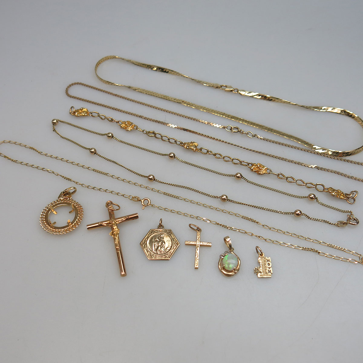 Small Quantity Of Gold Chains And Charms