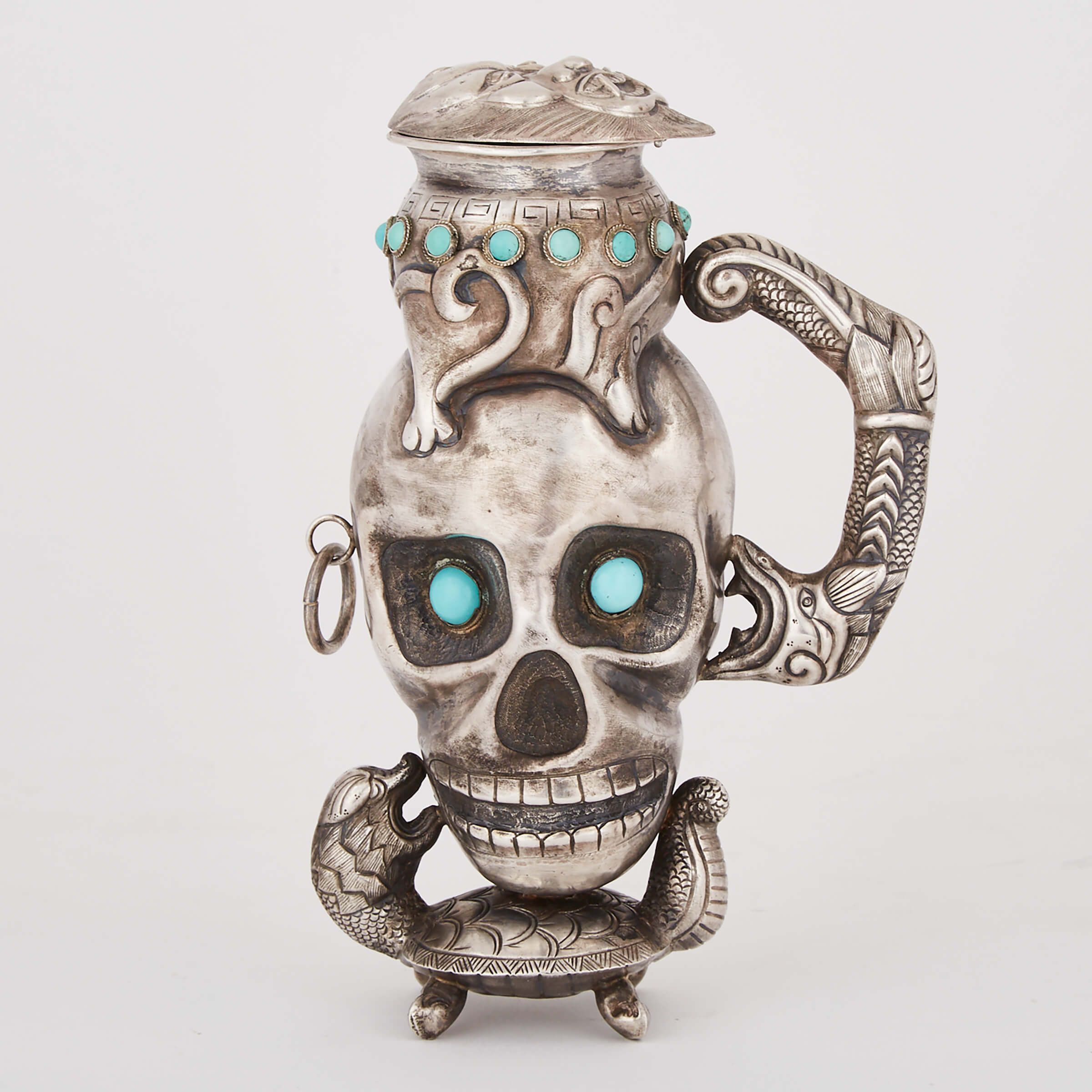 Indonesian Turquoise Inset Silver Skull Form Jug, early 20th century