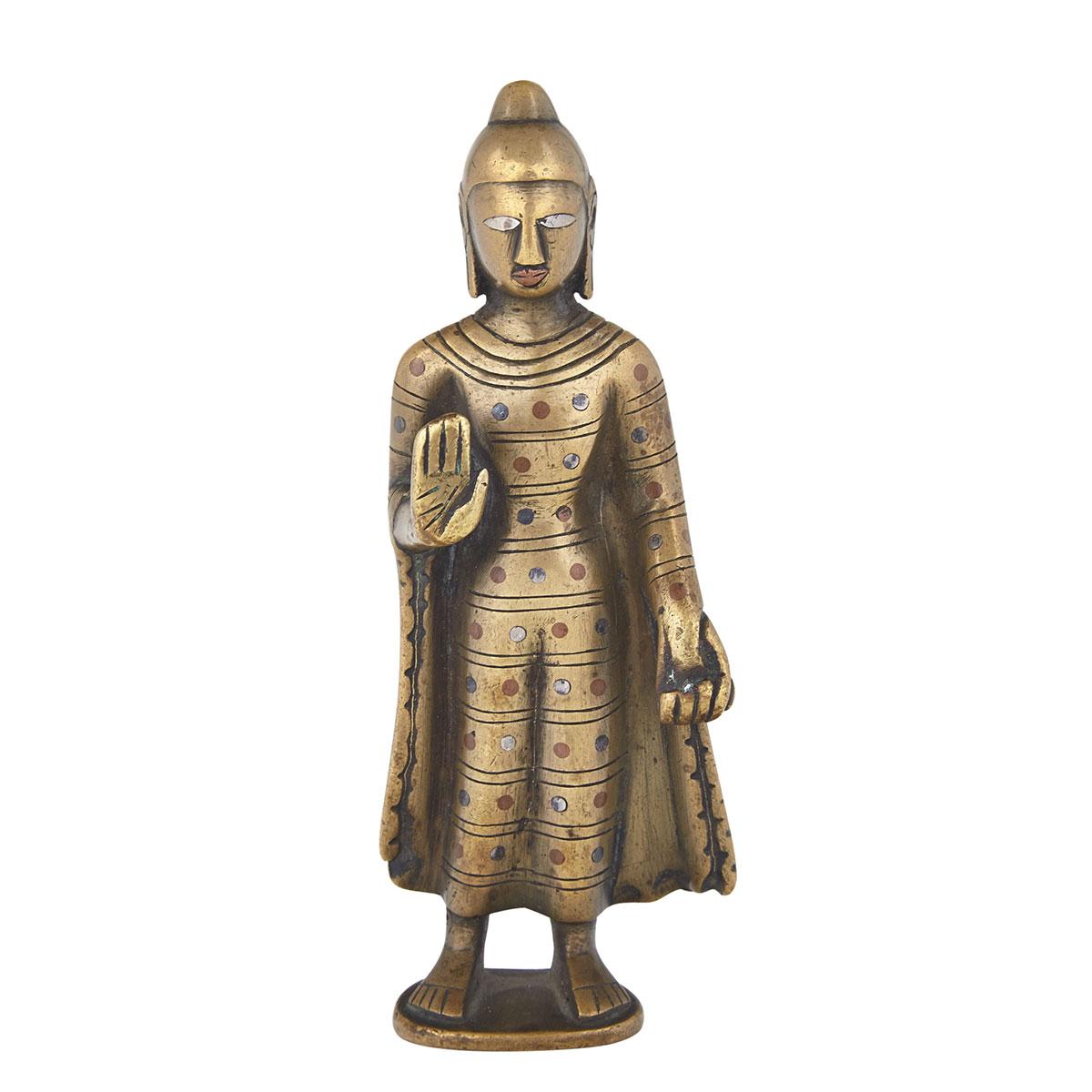 Small Standing Bronze and Silver Inlay Figure of Buddha, North India, 15th/16th Century