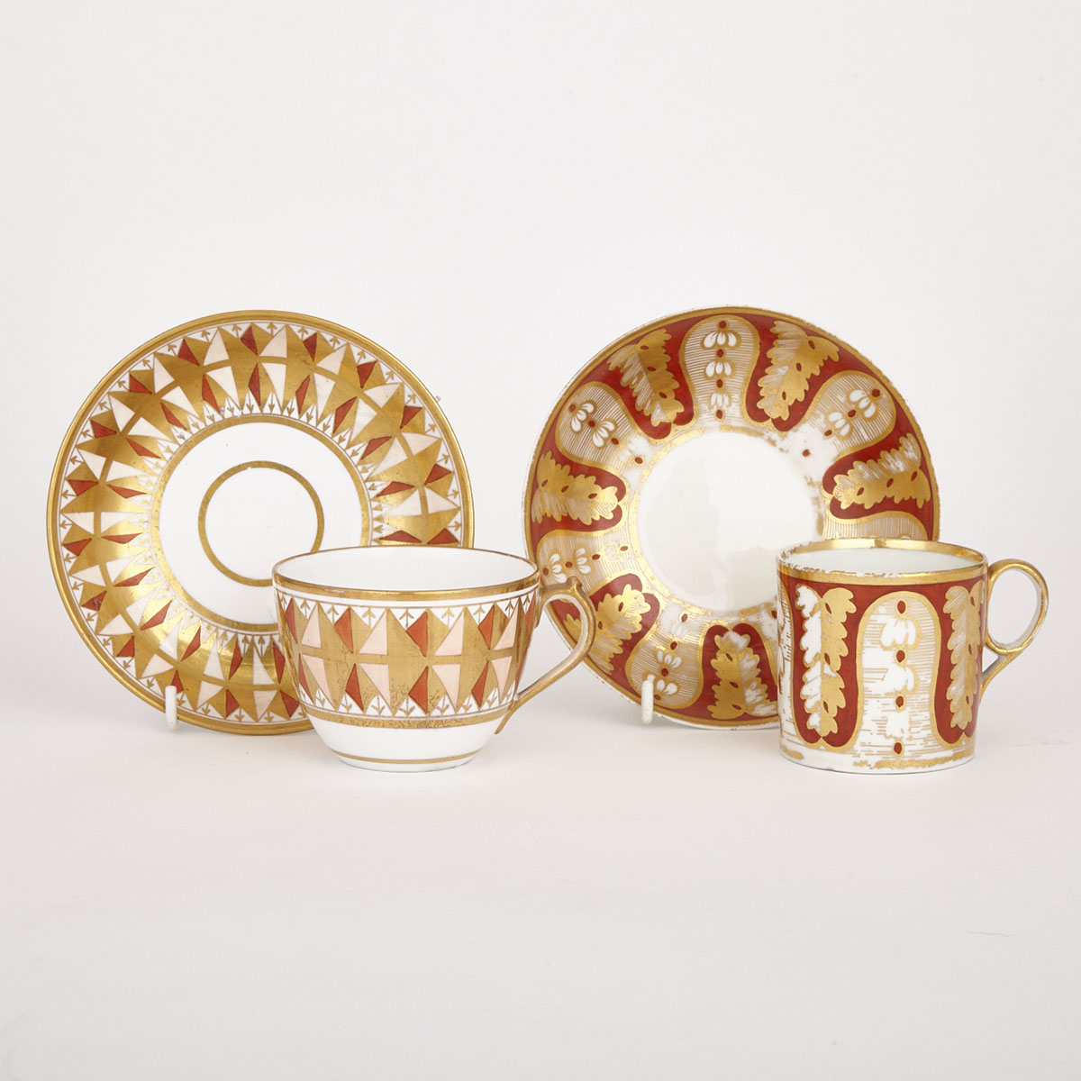 Two English Porcelain Orange and Gilt Decorated Cups and Saucers, one Derby, early 19th century