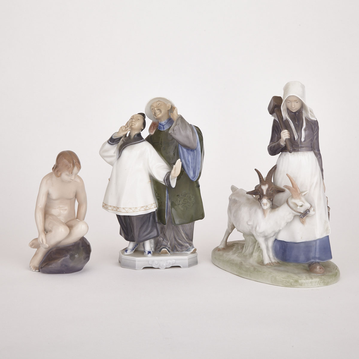 Three Royal Copenhagen Figures and Groups, ‘Girl with Goats’, ‘The Nightingale’ and ‘Nude Girl on Rock’, 20th century 