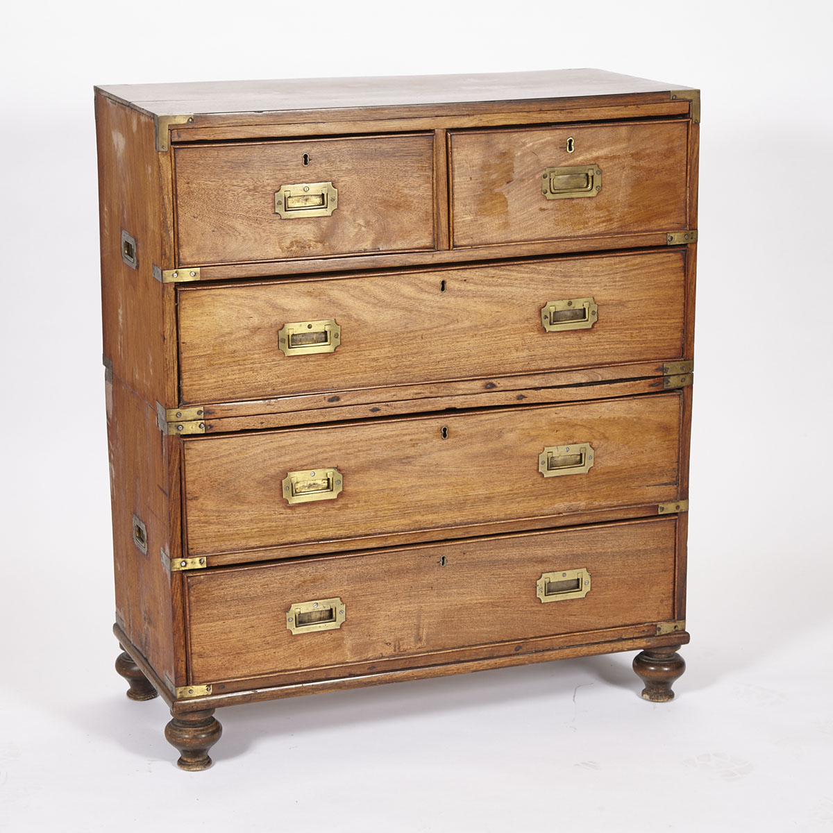 Rosewood Two Piece Campagin Chest of Drawers with brass mounts and raised on bun feet 