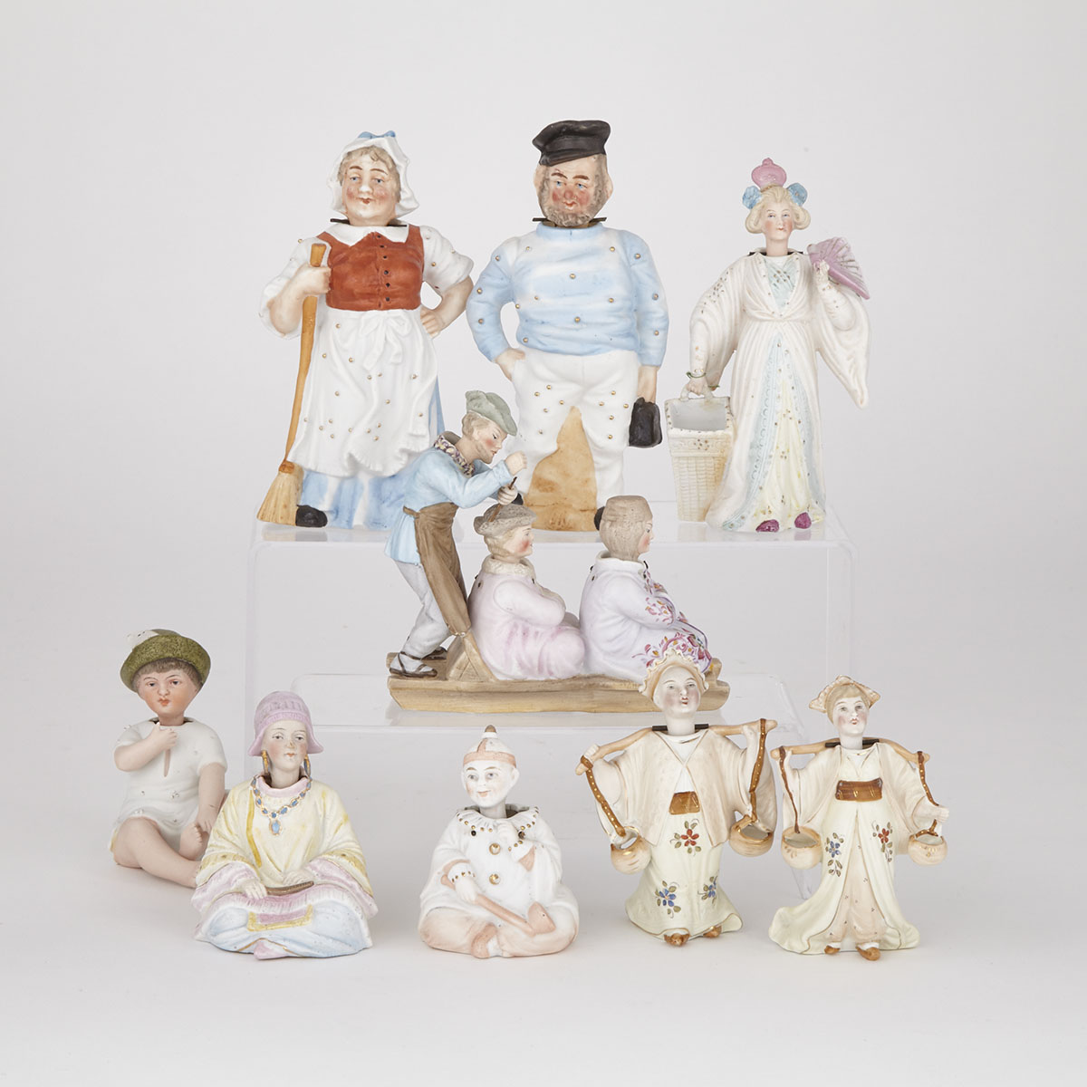 Nine Continental Bisque and Glazed  Porcelain Nodder Figures, late 19th/early 20th century