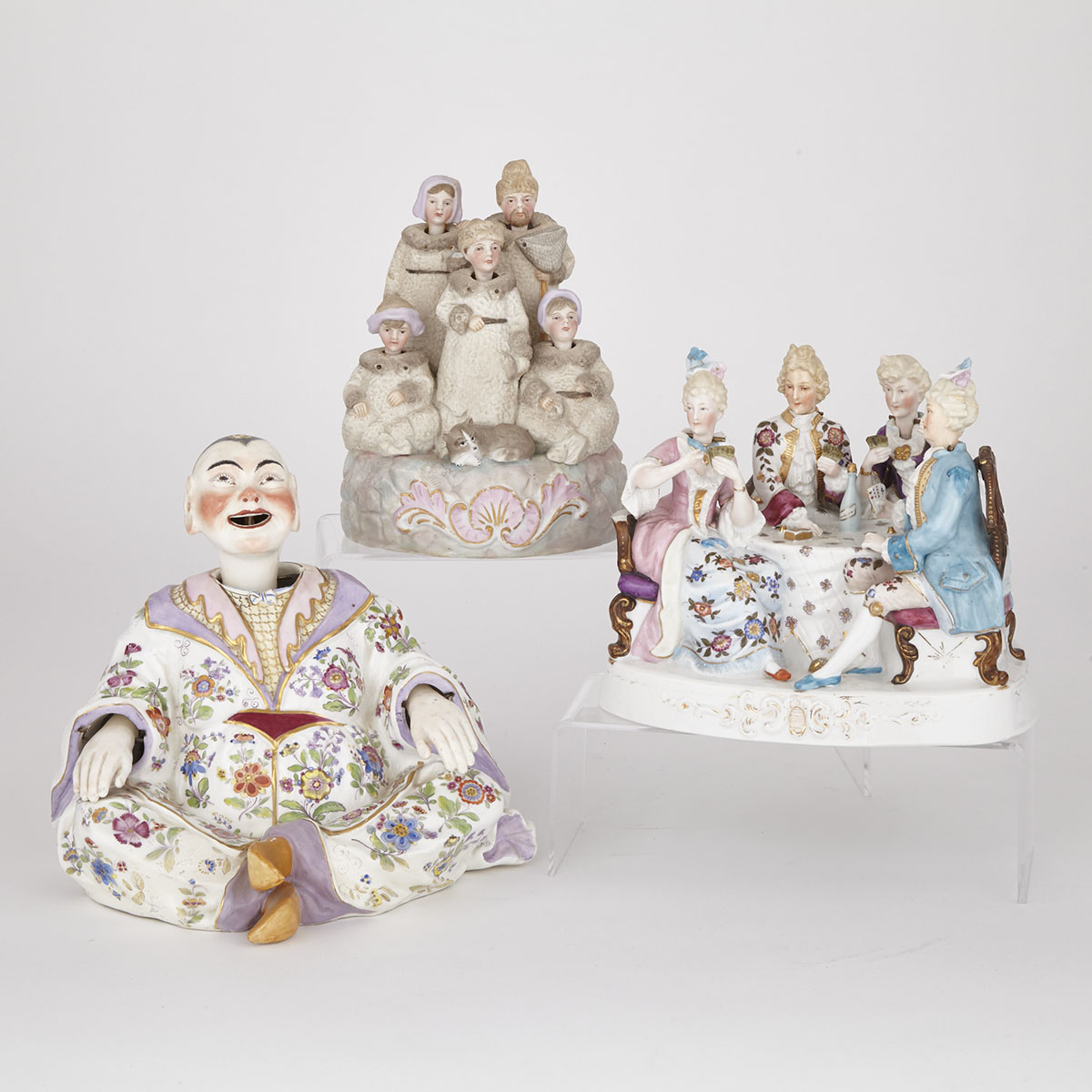 Two Continental Bisque and Glazed  Porcelain Nodder Groups and a Pagoda Figure, late 19th/early 20th century