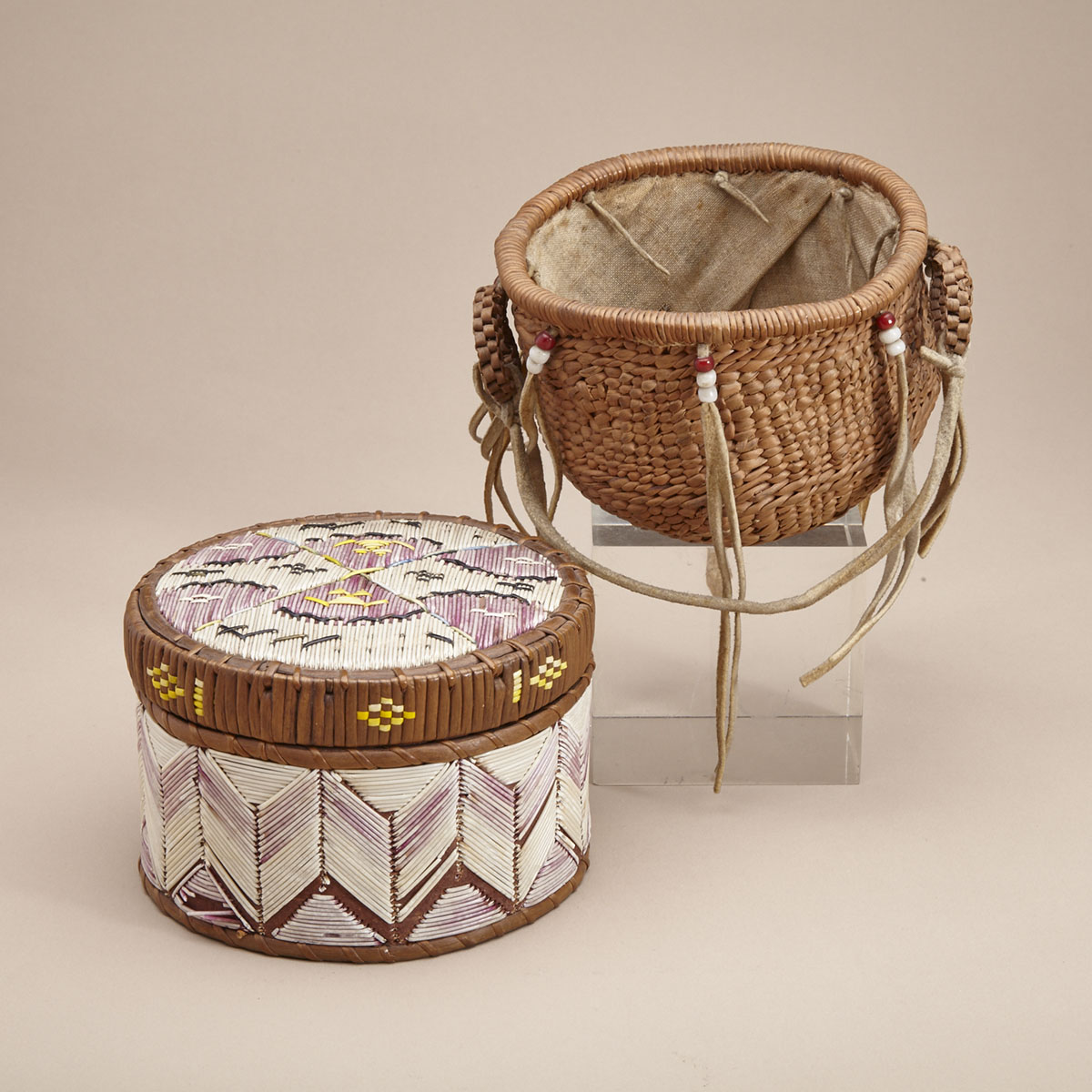 FABRIC LINED BASKET WITH HANDLES AND A SKIN STRAP, DECORATED WITH TASSELS WITH RED AND WHITE BEADS; MI'KMAQ QUILL BASKET
