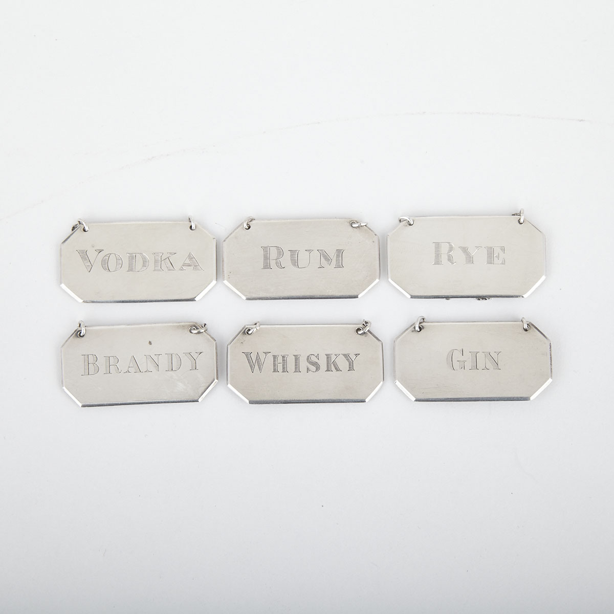 Three Canadian Silver Decanter Labels, The Silver Shop, Vancouver, B.C., together with Three Similar Plated Labels, 20th century 