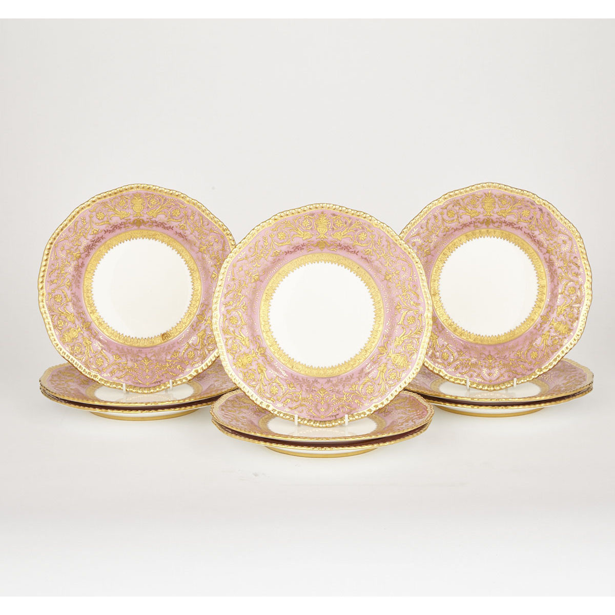 Nine Coalport Pink and Gilt Banded Service Plates, 20th century