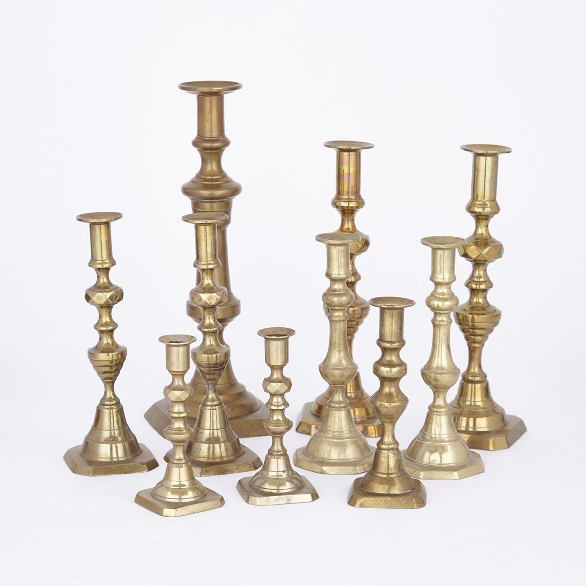 Ten English Brass Candlesticks including Four Pairs and two singles, early 19th and 20th centuries