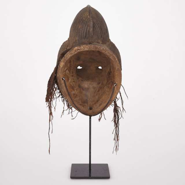 Punu Ocuyi Carved and Painted Wood Female Mask with fiber and beaded decoration, Central Africa, 20th century
