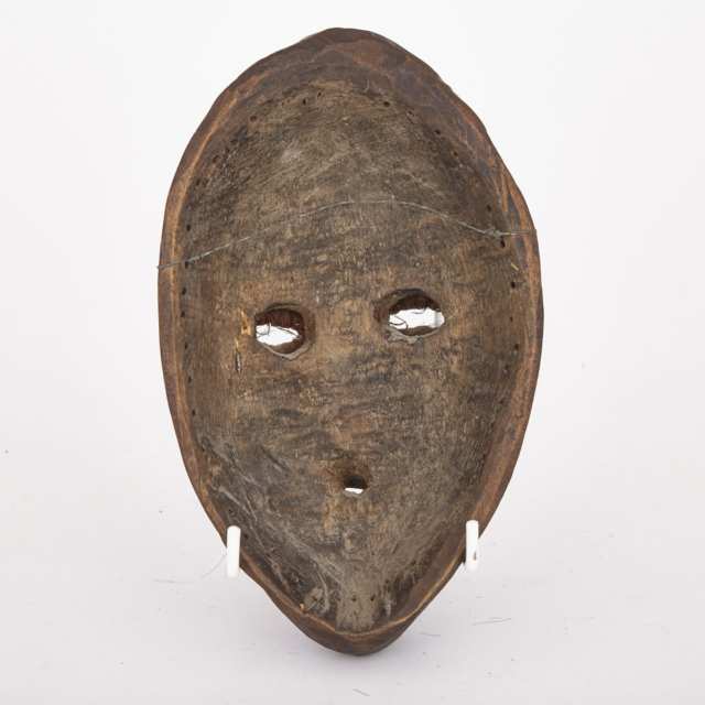 Dan Carved Wood Mask with applied hair, hide and metal decoration, West Africa, 20th century