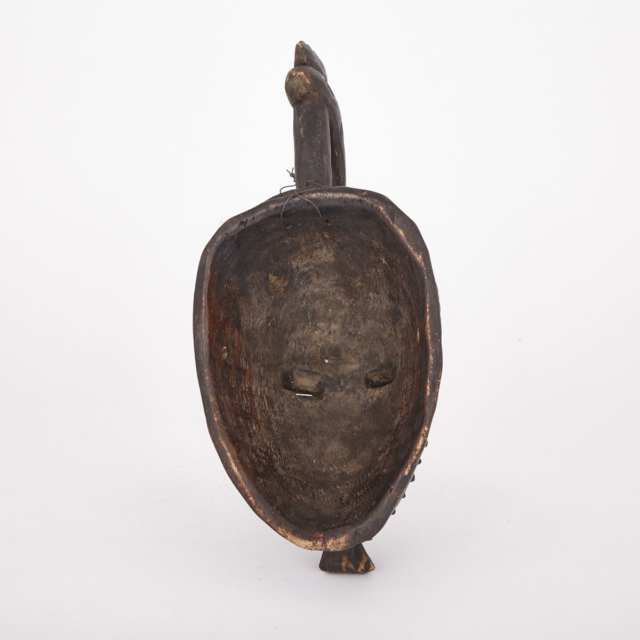 Dan Carved Wood Mask and Headdress with cowrie shell, cloth and fiber decoration, West Africa, 20th century
