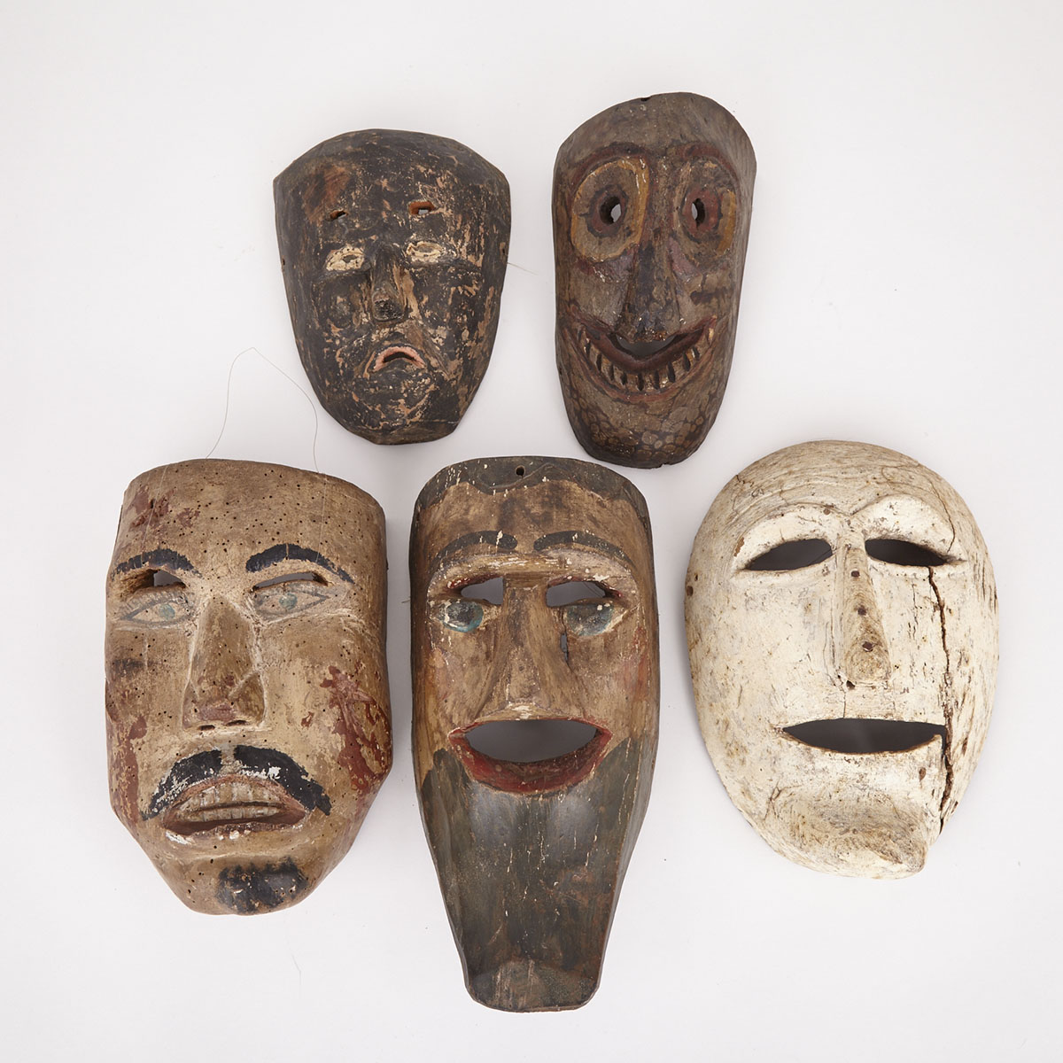 Group of Five Carved and Painted Wood Figurative Masks, 20th century