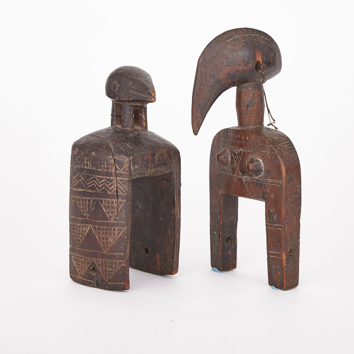 Senufo Carved and Painted Wood Heddle Pulley together with a Bird Form Heddle Pully, former West Africa, latter Africa, both 20th century
