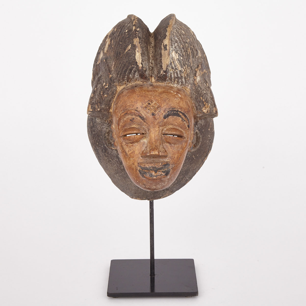 Punu Ocuyi Carved and Painted Wood Female Mask, Central Africa, 20th century