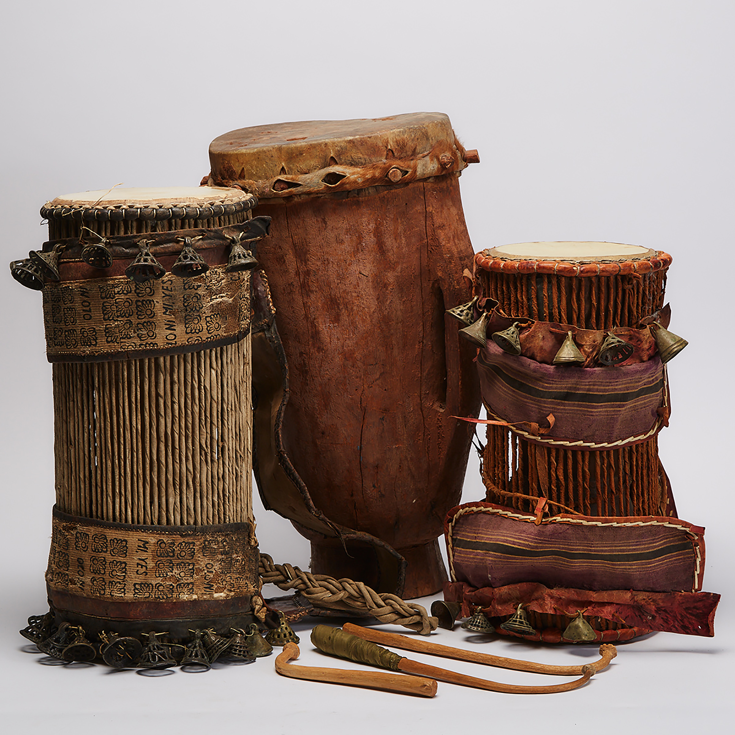 Two Talking Drums together with a single headed drum, Africa