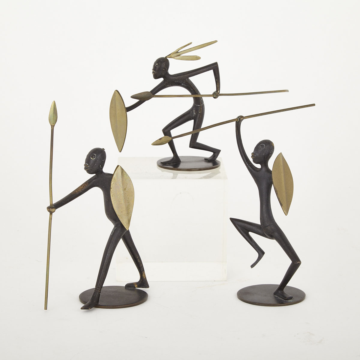 Three Hagenauer Gilt and Patinated Bronze ‘African’ Warrior Figures, mid 20th century