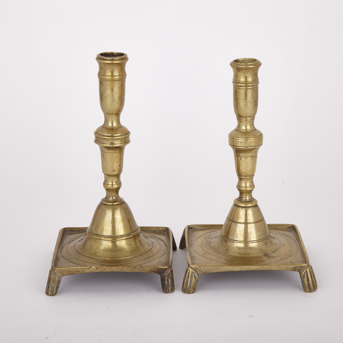 Near Pair of Spanish Bell Metal Candle Sticks, late 17th century