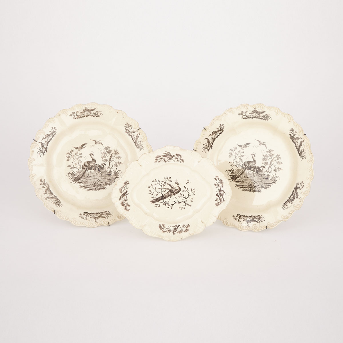 Two English Creamware ‘Liverpool Birds’ Plates and an Oval Dish, late 18th century