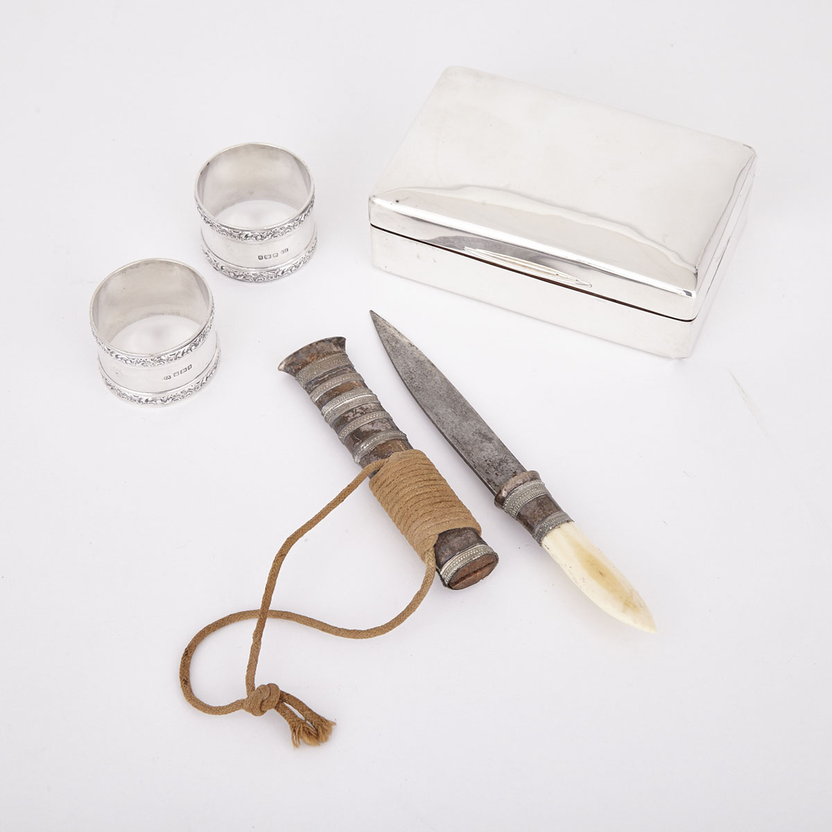 English Silver Cigarette Box, Two Napkin Rings and an Eastern Silver Mounted Dagger, 20th century