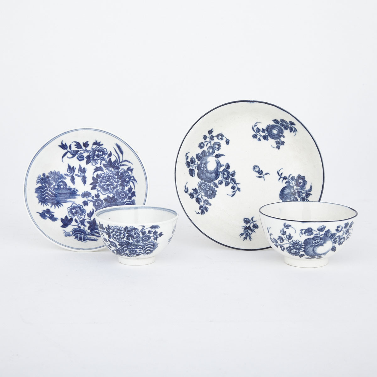Two Worcester Blue Printed Tea Bowls and Saucers, ‘Fruit Sprigs’ and ‘Fence’ Pattern, c.1770-80