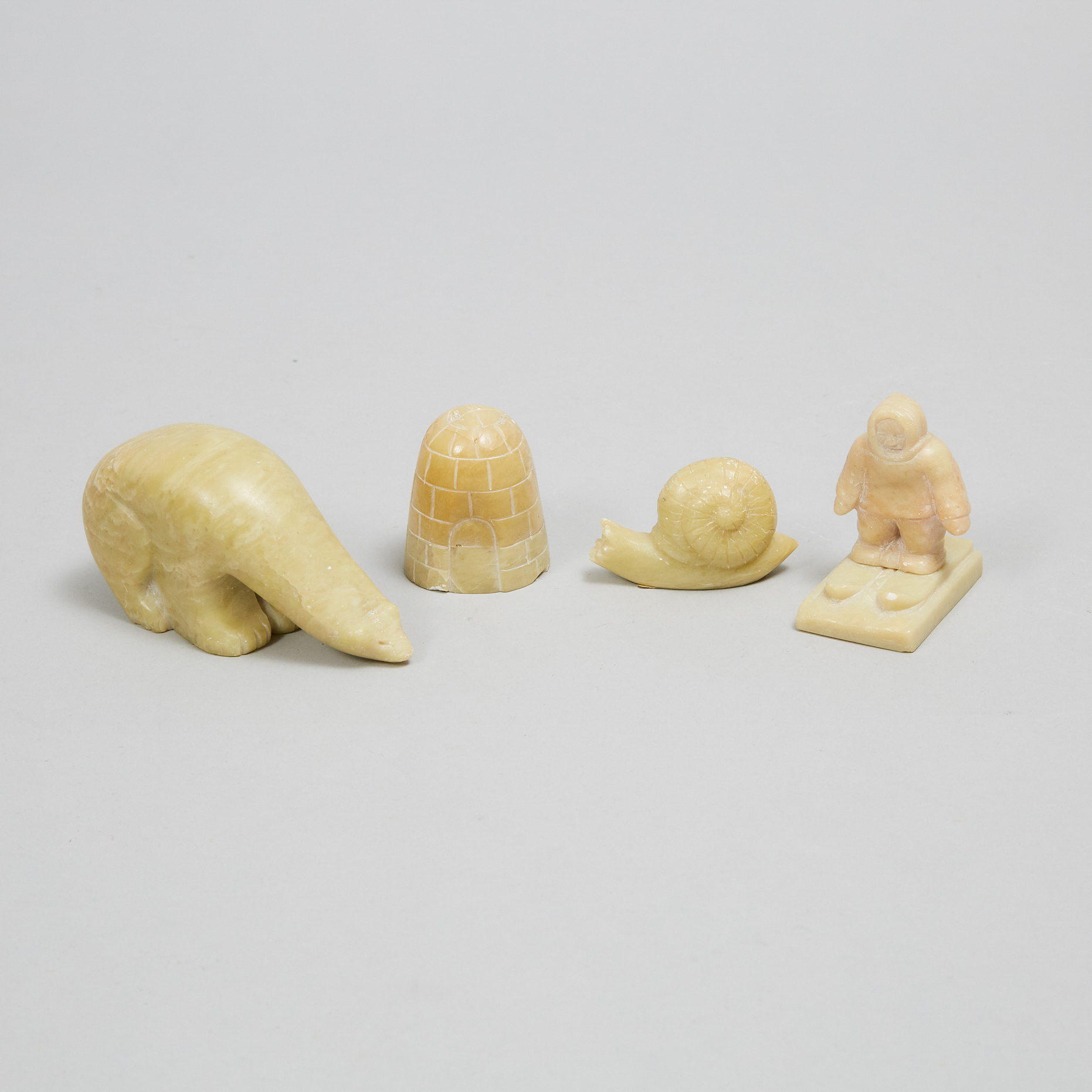 Four Small Grenfell Labrador Industries Carved Serpentine Figures, mid 20th century