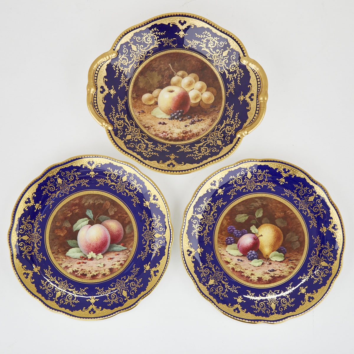 Pair of Coalport Blue Ground Fruit Decorated Dessert Plates and Two-Handled Serving Dish, Percy Simpson and Frederick Chivers, early 20th century