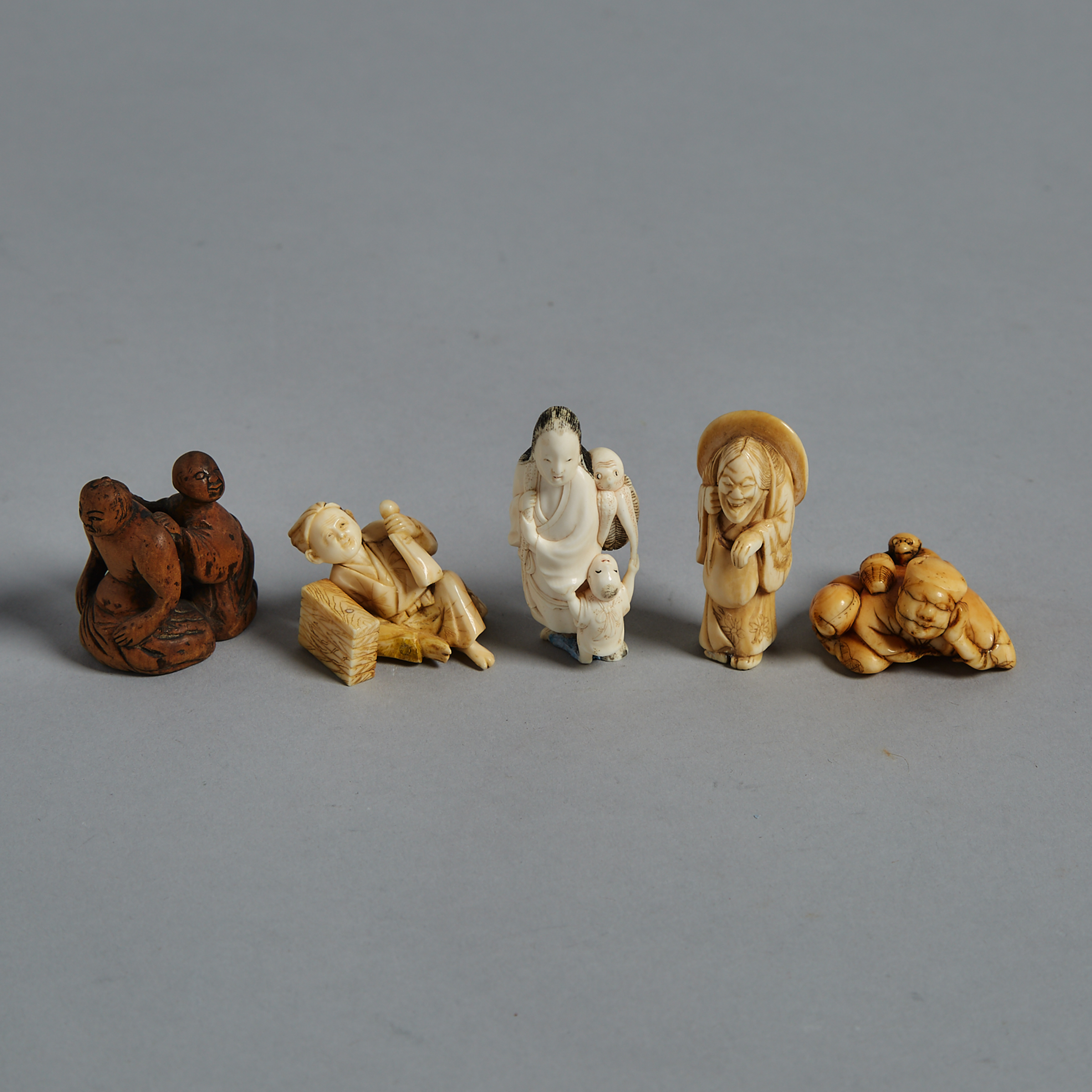 A Group of Five Ivory, Bone and Wood Carved Netsuke, Meiji Period