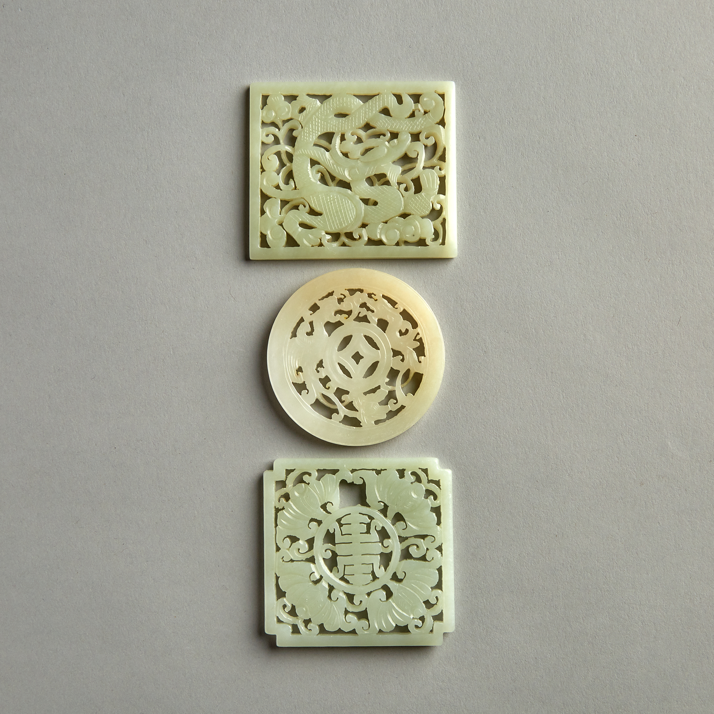 A Group of Three Reticulated Jade Plaques