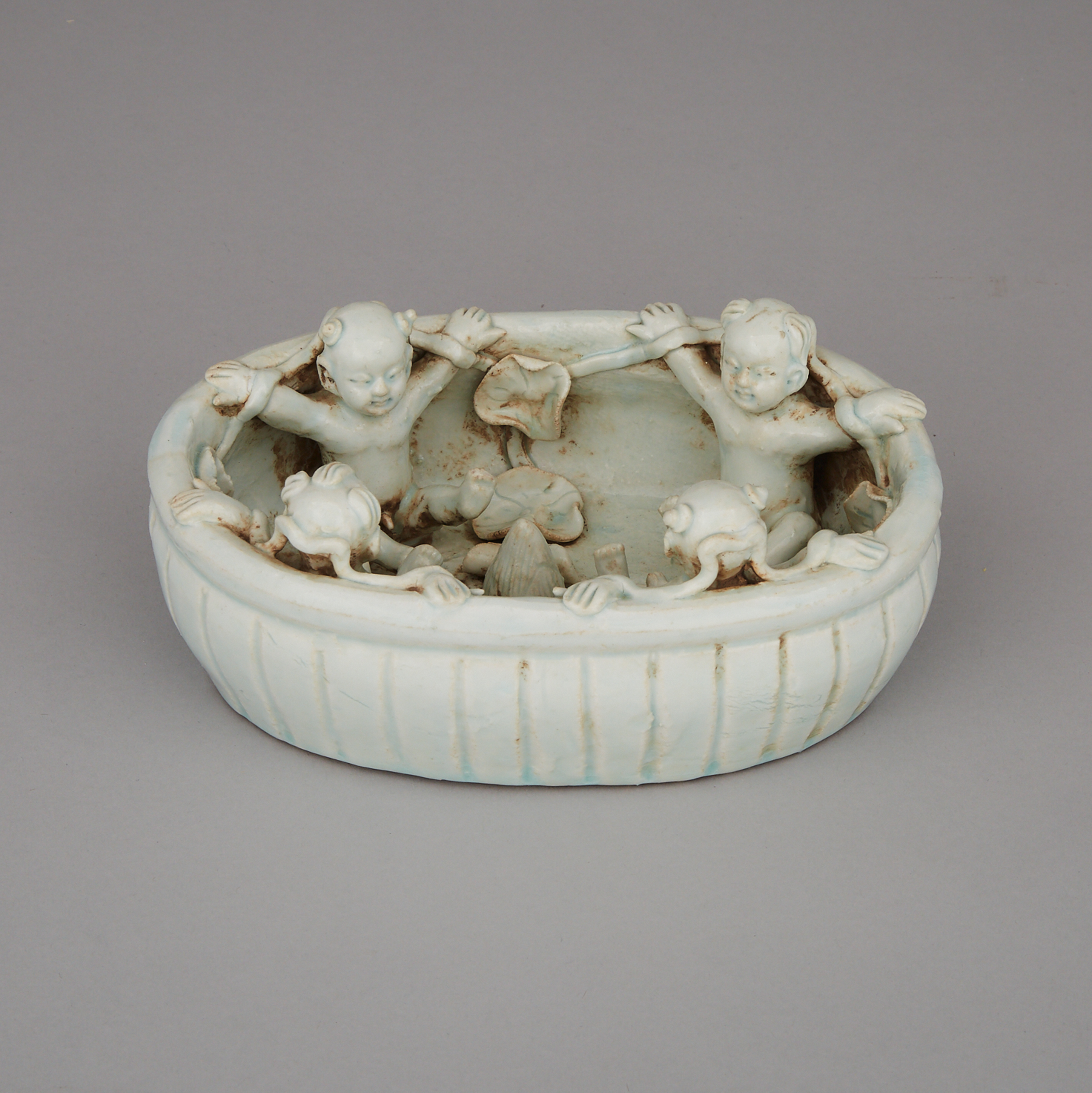 A White-Glazed Moulded Basin with Boys