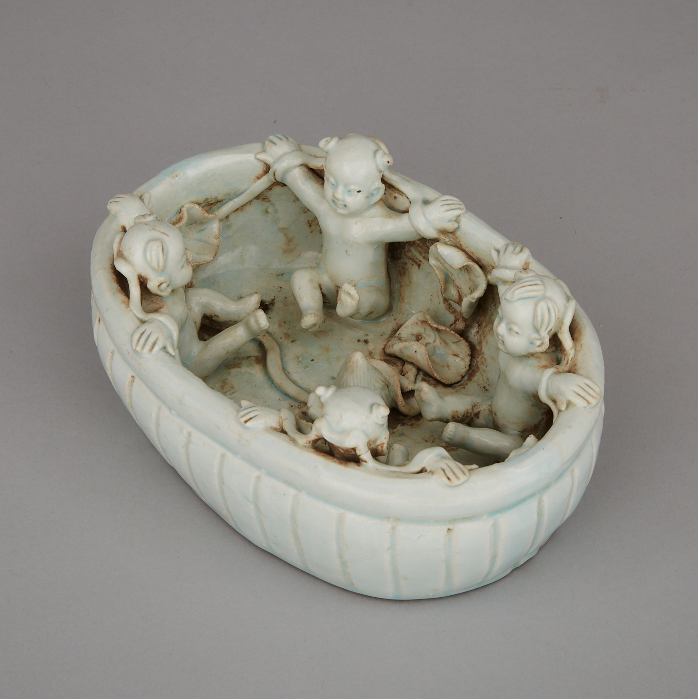 A White-Glazed Moulded Basin with Boys