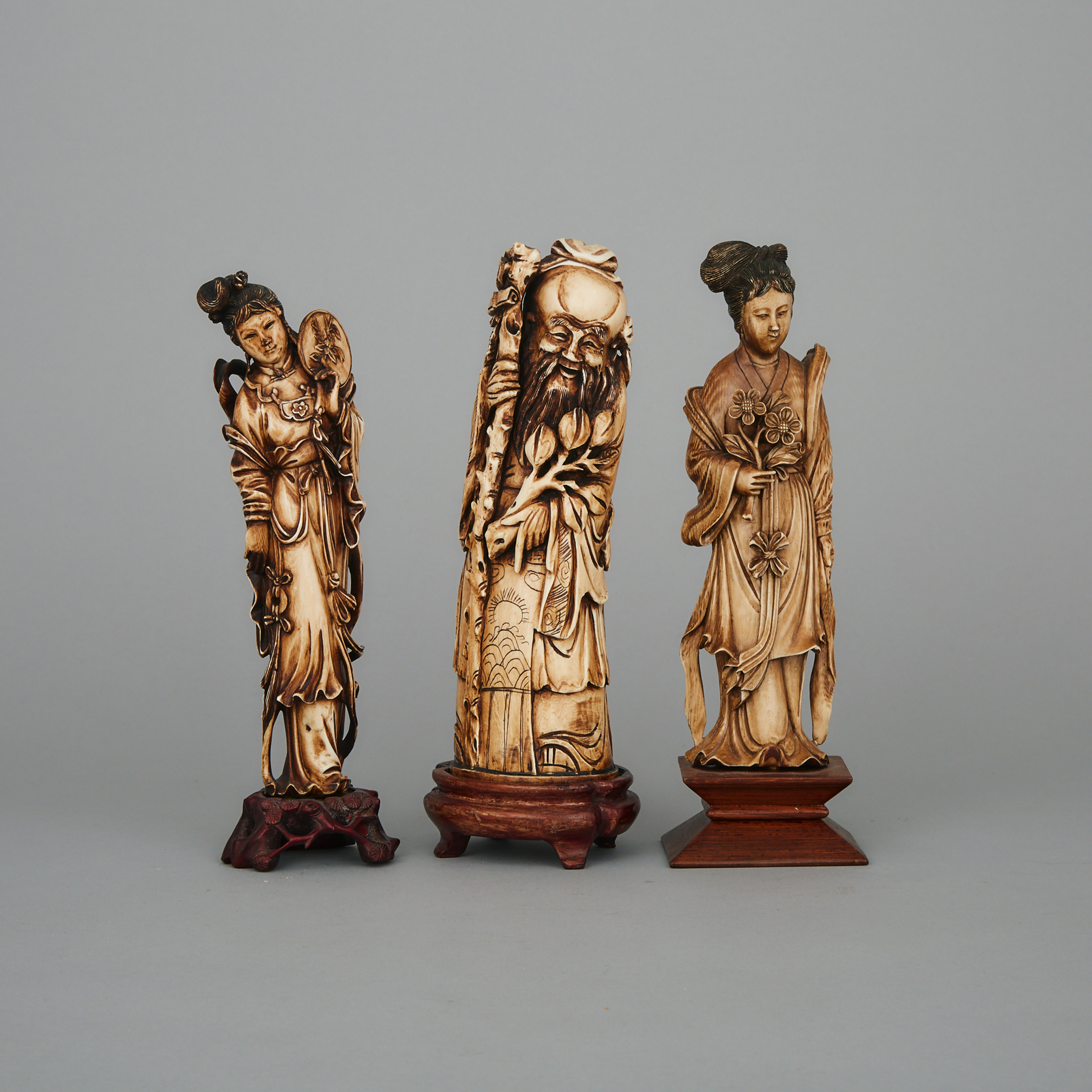 A Group of Three Ivory Standing Figures