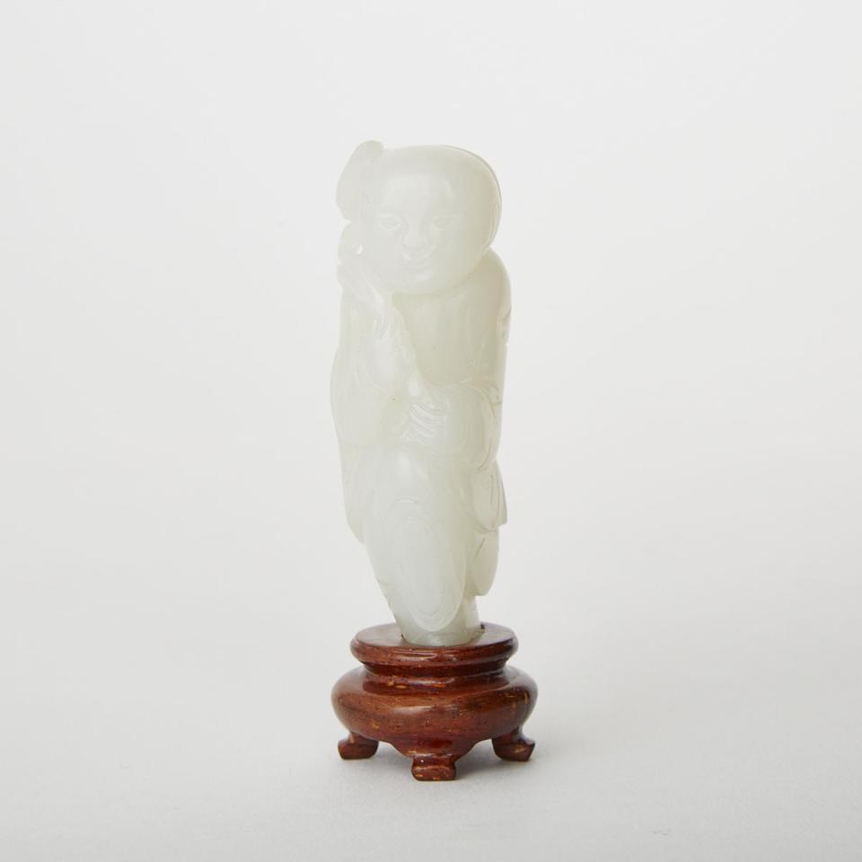 A White Jade Carving of a Boy Holding a Lotus