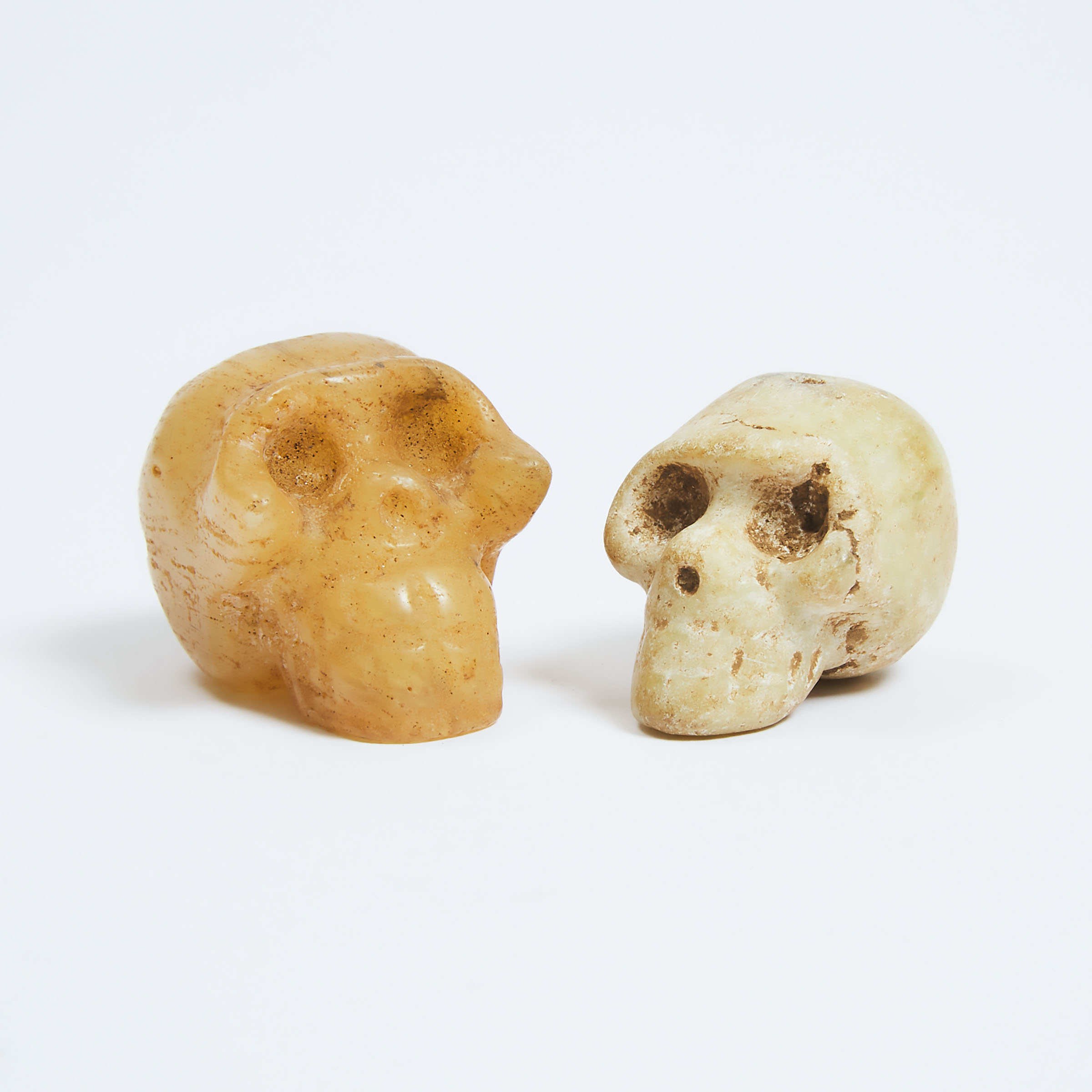 Two Archaic Carved Hardstone Skulls