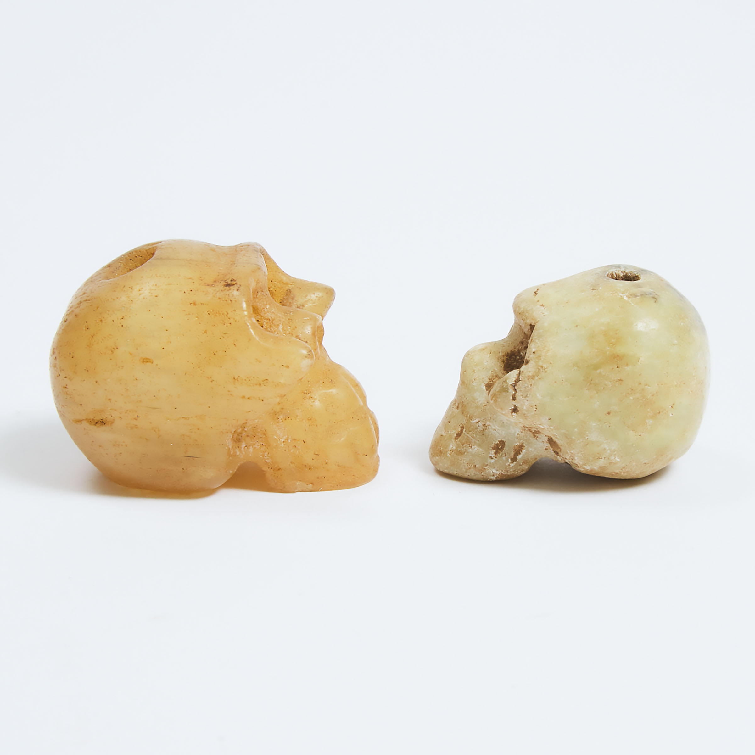 Two Archaic Carved Hardstone Skulls