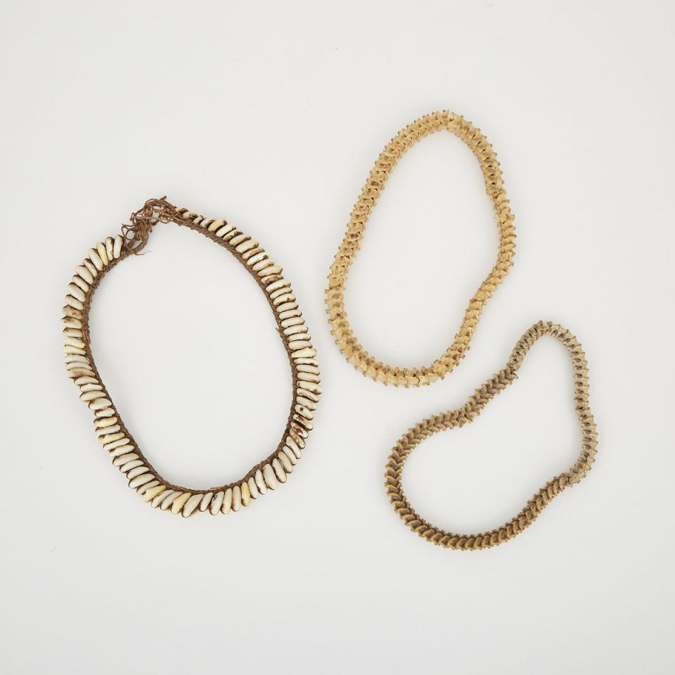 Two Snake Vertebrae Necklaces together with a cowrie shell necklace