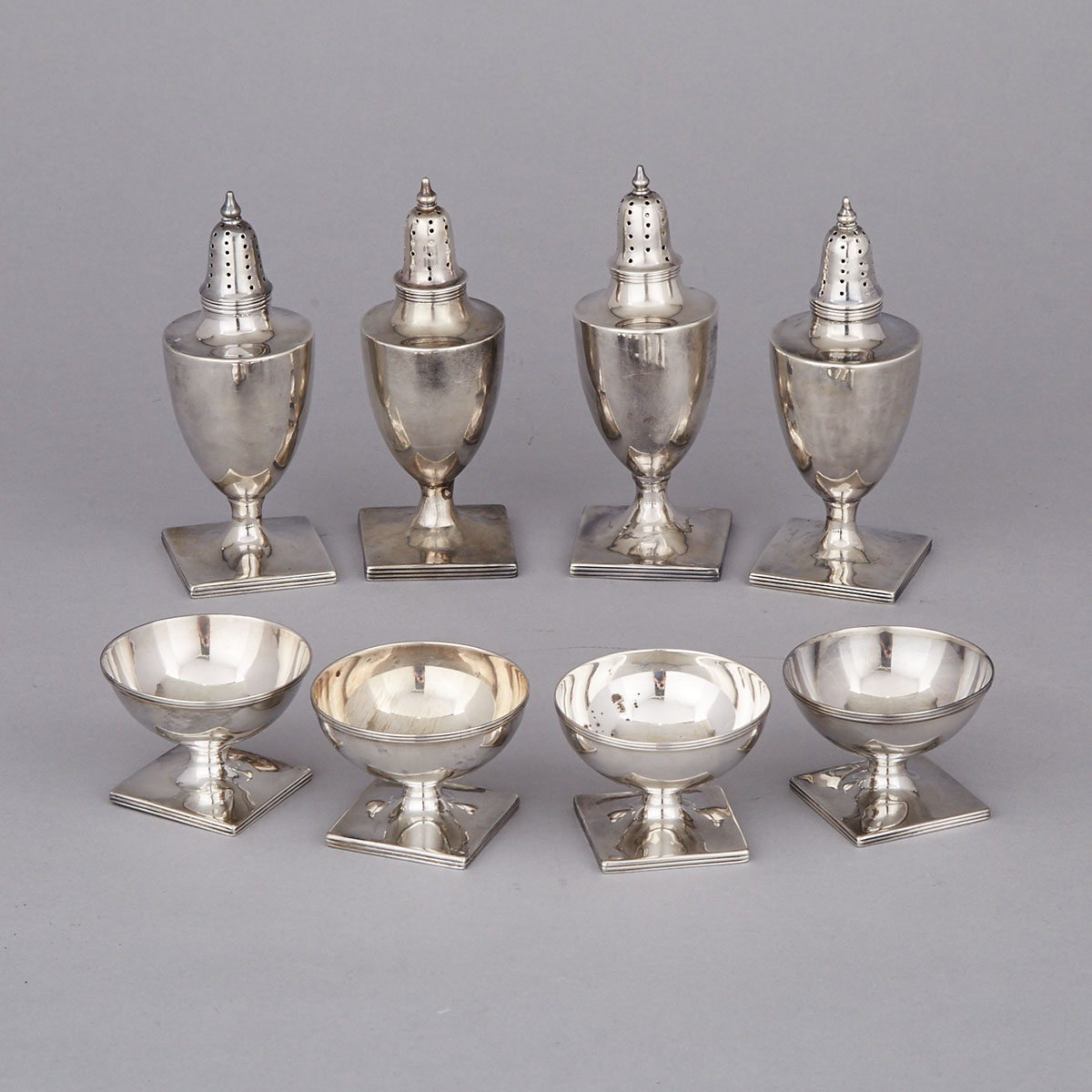 Four George III Style Silver Pepper Casters and Four Salt Cellars, 19th century