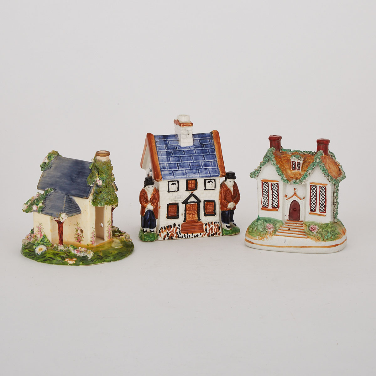 Two Staffordshire Pottery Cottage Banks and a Porcelain Pastille Burner, 19th century