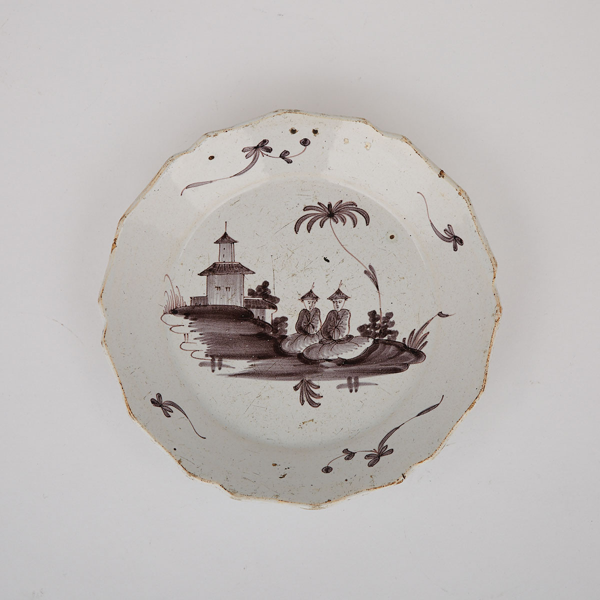 French Manganese Painted Chinoiserie Faience Plate, La Rochelle, 18th century