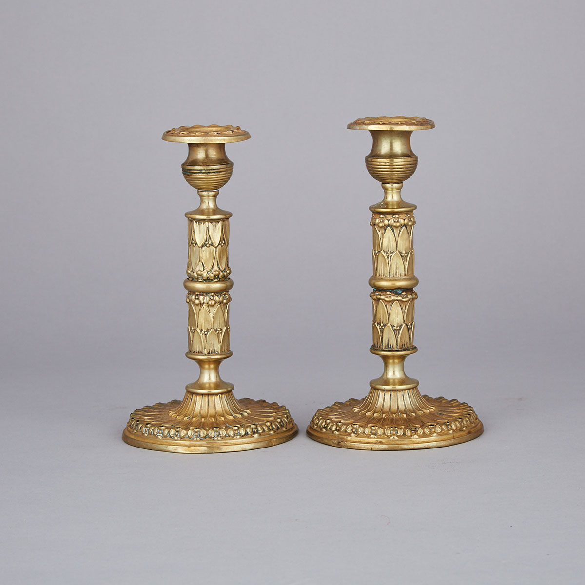 Pair of Gilt Pressed Brass Candlesticks, mid 19th century
