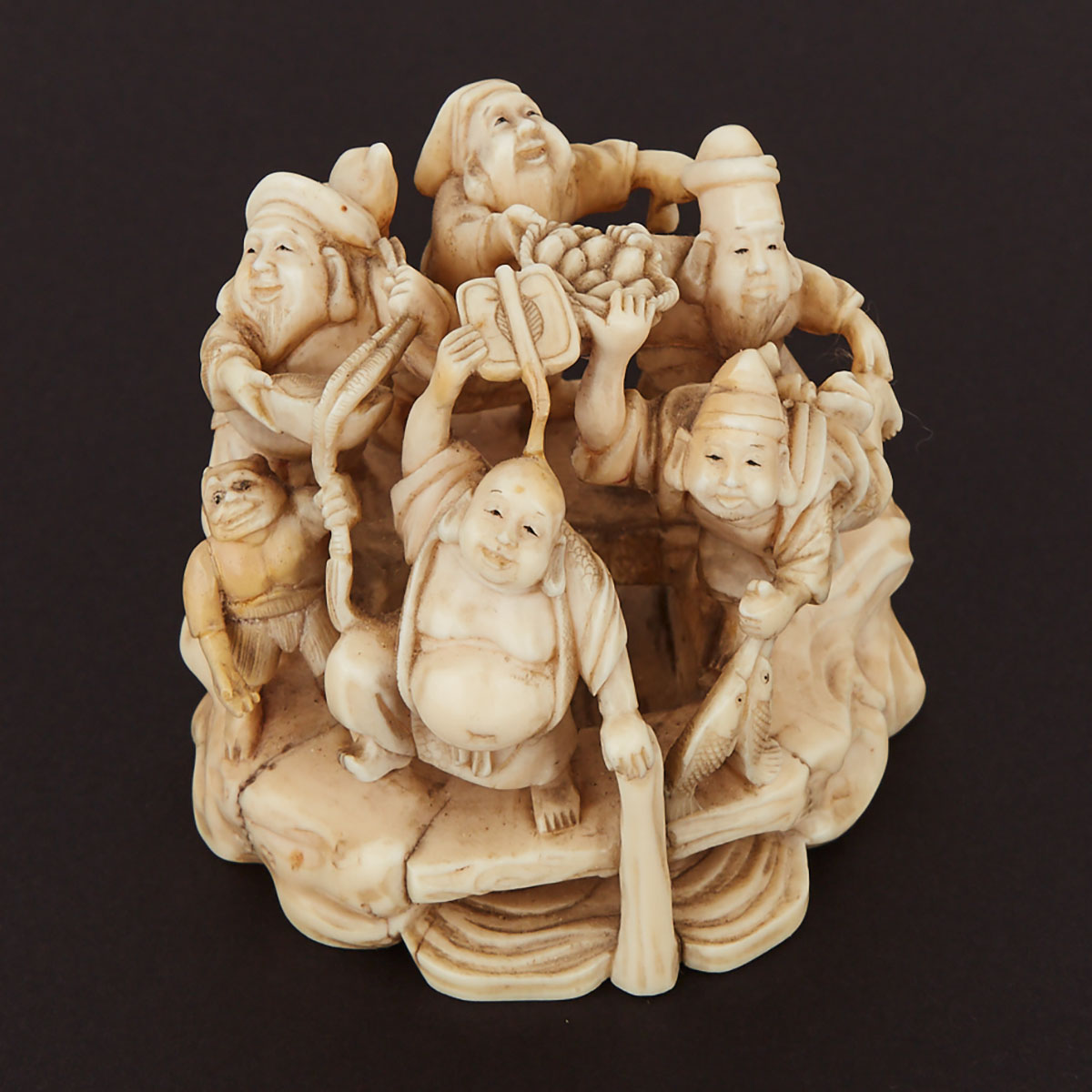 Japanese Carved Ivory Okimono Group of a Procession of Immortals on a Bridge, early 20th century
