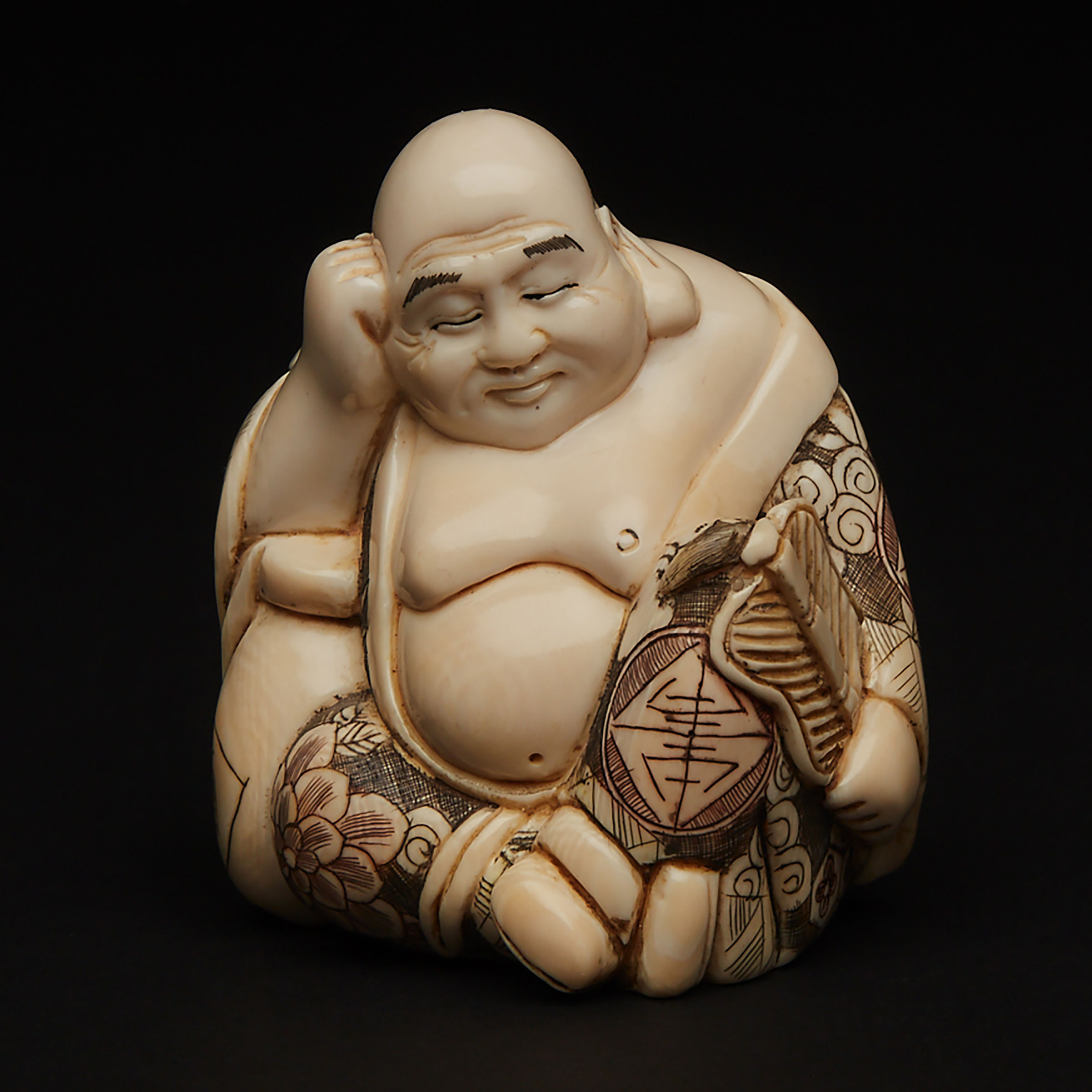 An Ivory Carved Okimono of a Sleeping Budai