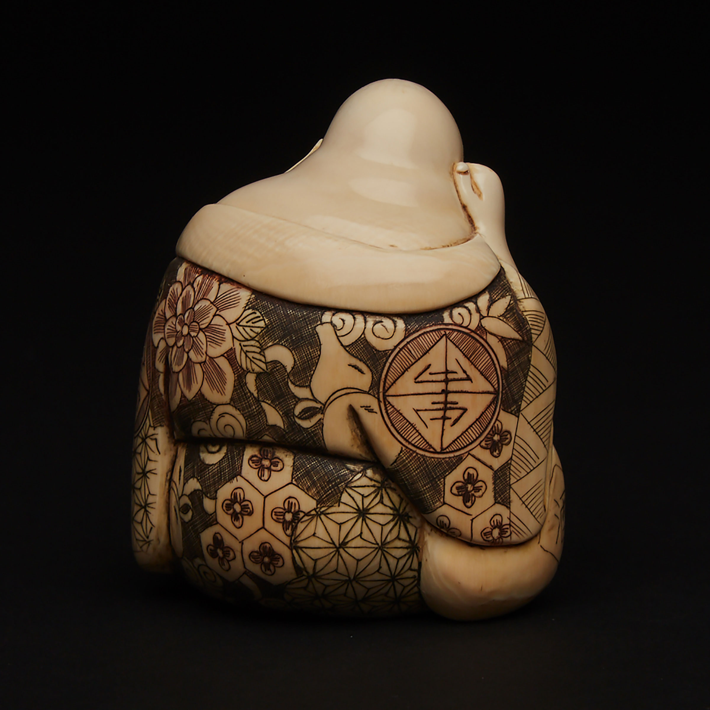 An Ivory Carved Okimono of a Sleeping Budai