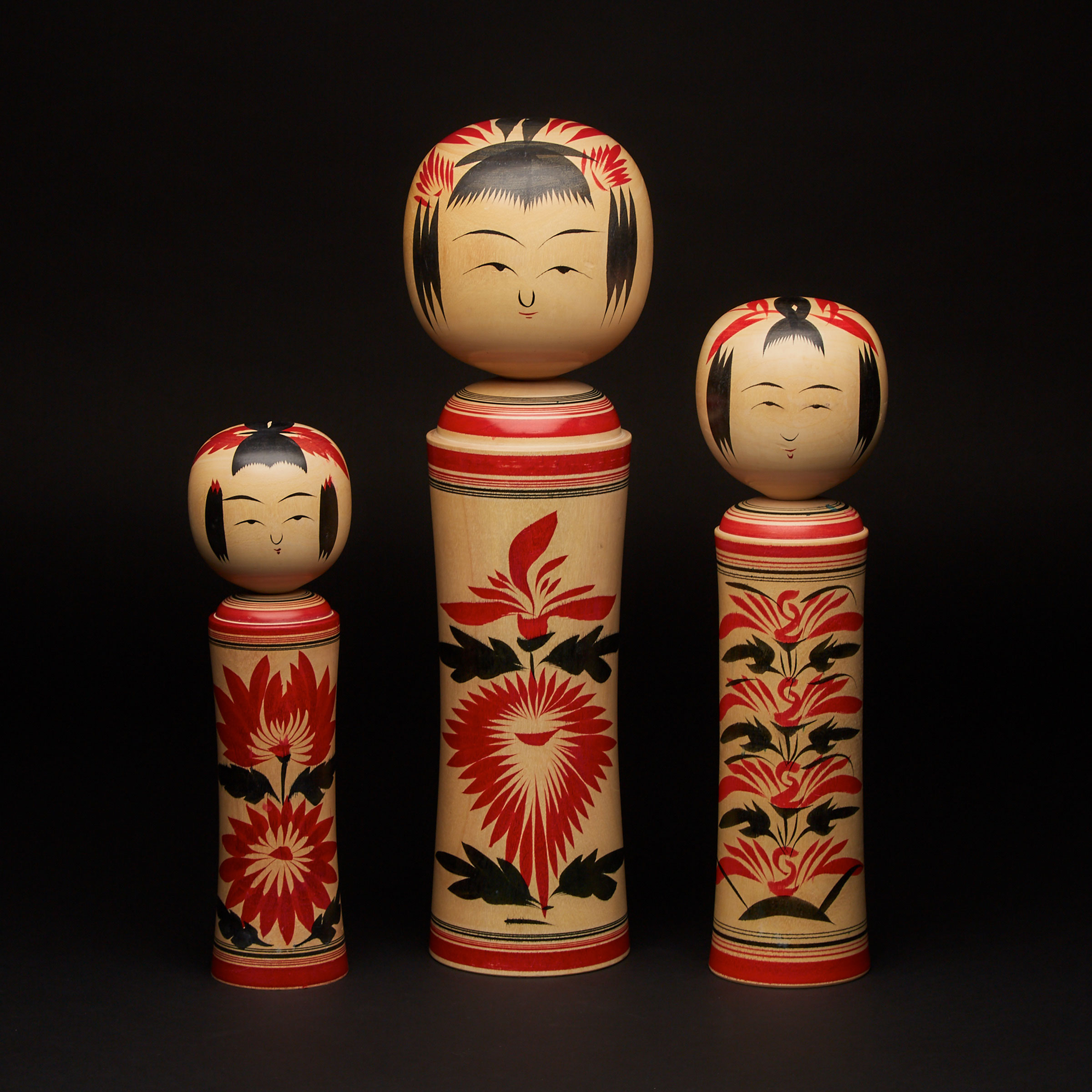 A Group of Three Kokeshi Dolls 